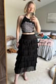 I ended up returning this, just because I couldn't find enough things to wear with it. The skirt itself runs a little large and sits lower on the hips, versus at the waist like normal. It's pretty long and falls about mid-calf. There's a lot of material with it, but it's fun to swish. It was cute, just ended up not being my style. Did enjoy styling it a little emo; it was fun. - Elizabeth S.