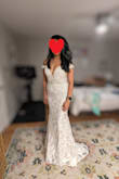 Beautiful dress. I love the low cut in the front and the off-the-shoulder look. I also enjoy the corset style with the built-in bra. However, it was an effort to squeeze into the dress. The website suggested I needed a size 4, but I chose a size 6. I would most likely have to go up a size if I decided to stick with this dress. In addition, the dress was too long, so I would have to get it hemmed (which is not surprising since I am 5 feet tall). In the picture, I am standing on a stool that is about 8 inches tall. - Adriana O.