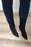 The boot size itself was true to size, but if your calves are on the thicker side (mine are slightly) they will fit tight. In my case they fit to the point they were tight but not uncomfortable. I think that's why it doesn't end up having that western look as much because calve area of the boot is slimmer than the photo. Beside that I was still able to wear over a skinny Jean! The boots are still very sexy!!! Right height too! Not too short or too tall and super comfortable to walk in all day long! If you're looking for these kind of boots, these are your girls! - Debora A.