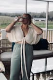 I absolutely love this top. So beautiful and the material was great. I went with an XL which was a tiny bit big but easily made it work by tying it tighter. I felt great and received a lot of compliments. - Heather R.