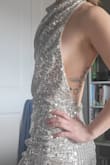 I was choosing between a few options for a Vegas wedding and as soon as I put this on I knew "This is it"-- it is shiny and elegant,  no bra needed! The material is good quality too! I tried it on twice and haven't found any sequins on the ground :) - Haley J.