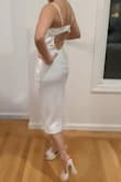 It's just a perfect little white dress! It's simple but sleek and fits perfectly! The fabric is smooth and the straps are adjustable. The back is not too low either which is a plus. I was on the hunt for a variety of LWDs to wear throughout my engagement and this was the perfect rehearsal dinner dress! - Beatriz K.