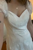 This had a very flattering cut and was comfortable, and I love the sweetheart neckline. I think if this had a more intricate floral pattern, I would have probably picked it for my wedding. I just felt like the sparse flower pattern was a little 'meh' in person. It definitely would look a lot better with an extra layer of lining underneath so that it was perfectly opaque (there were darts down the front that were quite visible). - Emma W.
