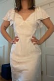 I LOVE this dress! The cut is so beautiful. It's comfy. The fabric pattern is fancy, sparkly and intricate. The flouncy sleeves are so precious! The deep V is flattering! However, like another review said, the cups do sit a little high. I think some boning/structure would help it sit properly (or if I filled it out more, haha). The sleeves have some elastic, and I could see this being a really sexy off-the-shoulder dress. Now, this gal is gorgeous, but I'd definitely need the waist taken in quite a bit (I'm between a small and a medium, so this was expected). Boning would help a lot so it sits properly. I was able to zip it up on my own, which is nice. Definitely [add] another lining/layer (you can tell right under the cups in the first image that it is more opaque there than the rest of the dress). I did not steam this before trying on and taking photos... Honestly, I am between this dress and another one from Lulu's for my budget wedding. We'll see what I end up picking...! - Emma W.