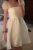I had been looking at this dress for a little bit, but it did not have any reviews. I wanted it for my university graduation photos, so I didn't want to risk it. BUT I ended up buying it anyway and loving it even more in person. It is not see through, laid just at my fingertips, and the bow on the back is just so perfect. The bow was also perfect because I was able bring the waist in a little more! The only slightly negative thing I have to say is that the puffs on the sleeves are a little bit itchy, but I got over that almost immediately! I hope this helps anyone interested! - Natalee W.