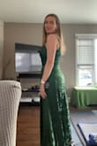 I purchased this dress as a bridesmaid for my sister's wedding. The color is a lovely dark green, and the fit is flattering on the tummy area. I can see how the hanging part in front might get a little wonky if folded up in a suitcase; that's my only concern. - Julie C.