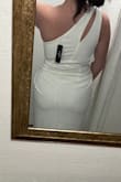 The material is nice and I love the style and fit of the dress. I got it in white so it is a little see through but if you go with a color I don't think you would have that issue at all. The front has the perfect design. - Emily C.