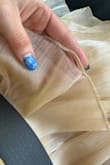 This dress is beautiful! I bought it for work photos, and everyone loved it! However, I wore it a second time, and these little [pieces] are popping up out of nowhere! I've worn the dress for photos and to church, so no strenuous activity is being done in it. Very sad considering the price - Hannah C.
