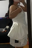 Originally I purchased this dress in a L. Normally I wear L. I read the reviews and I was leaning more towards a L. I tried the dress on but it didn't zipper all the way (zipper is on the left side) being that I am a little big on my bust I had to size up. When receiving the XL it fit a lot better! The only thing I couldn't really convince myself with was the side bow!
I really wanted this to be my dress for my Vegas wedding
Other than the bow, I really loved the material of the dress! No need for stickies, you can go braless.
Didn't work out for me but I'm sure it will look great on someone else :)! - Jacquelin V.