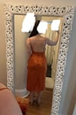 I'm attending a wedding in the desert and wanted something that would be comfortable in the heat and blend in with the landscape. So I got this dress in the rust orange color, and it's perfect for just that! Unlike many slip dresses, this is lined and feels like quality satin. It does need to be steamed, particularly the cowl neck which does lay funny, but it will look much smoother once it is. I love the low back, the open slit on the left side, and the rose pattern detail. I got a size small, and it fits exactly how I'd want it to. - Katherine Y.