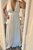 This dress is exactly as pictured I feel. Not cheap feeling material. Ordered for my beach elopement and it's PERFECT. It is a little on the long side but that's fine. - Maribel B.