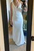 The dress fits well. Will need to get it hemmed at the bottom and will need to wear shapewear day of because it's tight. Not super thick fabric but also not paper thin. - Allissa R.