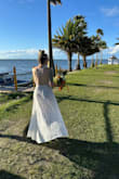 I was utterly enamored with wearing this dress on my wedding day. As Florida natives, my husband and I opted for a picturesque ceremony aboard an airboat at sunset. The dress seamlessly combined comfort with allure and sophistication. It garnered numerous compliments, and I'm thrilled with my decision. Though minor alterations were needed to lift the straps and adjust the length, the overall fit was impeccable. This stunning gown celebrates beauty and elegance, flattering diverse body types with ease. - Julia V.