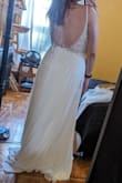 Decided not to keep it as it felt a little too informal for my wedding, but if I had been doing a beach ceremony, perhaps! It fits beautifully in the chest, but the strap in the back would have needed a fix so it didn't bag just slightly on the bottom in the back. Otherwise, it felt slimming and was beautiful and wasn't so long that I felt like my shorter frame was drowning in it. A nice dress for another occasion! - Kathryn A.