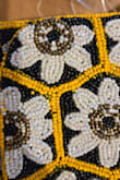 My friend had this and I loved it, so I ordered one for myself. When it arrived, I noticed something really weird. The yellow beads weren't that color yellow. They're a different tone of yellow, and then PAINTED that bright yellow. There was yellow paint all over the surrounding black and white beads, making it look really messy and odd. And the yellow paint is obviously only on the exposed side of the bead, so if they ever twist on the thread, which is likely, then the original color will be exposed. Honestly such a disappointment for what could be a seriously cute bag. Sending right back - Holly H.