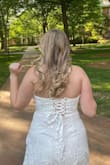 The material is not stretchy but I got the true to fit size the site recommended. I got it for graduation and graduation pictures. The flowers are so detailed and pretty in real life! - Lauren C.