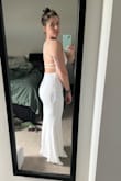 It is very stretchy and hugs all the curves.  I think I would have liked to try a M also, but I ended up wearing this for my wedding and loved it. - Darci B.