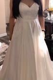 The skirt is full and the satin fabric flows super well! I will need to get some of the length taken off (5'7 wearing 2.5 inch heels). There is an interesting thick fabric just at the end of the dress, not sure how that will affect alterations yet, but I think it's to keep the weight of the outer skirt of the dress down. The strips are very much drawstring vibes, so I could see it causing pain if all the dress weight is on it. But the bust is tight enough for me that I didn't mind the thin straps. - J C.