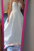 The dress is gorgeous. The slit is definitely waaaaay too high. It pretty much reached my lower abdomen. The top part and all the intricate and delicate beads are beautiful. The dress fits snugged for a size 2. I think this fits like an xs. If you are having a ceremony outside a church wear this. For me, it won't work. And my wedding is this winter. The dress is too heavy and I would need several alterations: adding sleeves or getting a topper, closing the slit, and shortening the length. So, if all you have to do is close up the slit a little and hem, then alterations not too bad. I will be returning, I ordered a different dress from Lulus. - Yuki G.