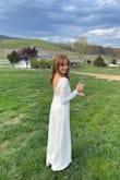 I had a knee length and mid-arm length dress for my Virginia 4/8 wedding day but the weather showed slightly cool. I needed something elegant and cover my skin, just as a backup. Just 6 days before, I searched everywhere online and luckily found this dress and paid a little extra for 2 day shipping. Though it was me, my husband, and the officiant everywhere we went that evening gals would stop me "love your dress!" "Your dress is beautiful" etc. I took a page from another gals post and I too trimmed the back fringe from the lace which showed a more elegant look. The left side thigh slit is a bit high - probably not best for a church wedding and would be challenging to west spanx any similar control top undergarment. I went with a basic nude thong. The fabric is quite nice given the low cost and very easy to iron day of. One challenging part: though I have broad shoulders, it kept slightly falling off so I had to keep a straight back throughout the ceremony and after but no biggie for overall look. - Amy S.