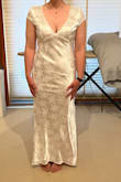 I love this dress! The back is so stunning. However, it's a little small in the bust for me and a little short in the front. I'm considering sizing up for the sake of the bust and then getting the dress altered but it could still work as is. The back is absolutely gorgeous and it flatters curves. I'm excited to wear it for my December wedding, the shiny material is very festive - Cassie D.
