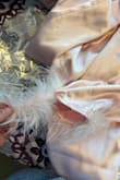 I just opened this package for a bachelorette party and the feathers were falling off of the bottoms and top. I'm not sure if the design is suppose to be that way or if I got a defective item but it looks weird and cheap with them not fully attached. Will be returning. - Andra K.