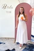 I ordered so many Lulu dresses to try for my bridal shower, and this was the keeper! I'd never really worn a backless dress before so it was a bit outside my comfort zone. However, I felt so beautiful and got so many compliments on this dress! I'm short - 5'1 - but the length was perfect on me (size small). I did steam the dress before wearing it and it didn't wrinkle all day, and the tie back was really good quality. I would recommend this dress to any bride or individual looking for an elegant white dress! - Ashlynn M.