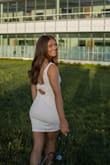The quality of this dress is awesome, I get a little nervous with white dresses being see through but did not have that issue at all with this dress. It fits a little looser than how I thought it would fit compared to the picture. This dress was perfect for graduation, super simple and love the open back. - Trinity L.