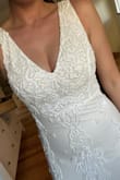I initially ordered a small because some reviews said it ran large but the small was too short. I exchanged for a medium and it fit perfectly. I have a sticky bra that fit perfectly under the dress. It is slightly sheer, so nude underwear or shape wear is necessary. - Ariel D.