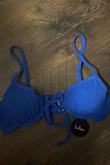 The fit is pretty good. It is a super cute bathing suit, and I love the underwire. The problem is that the wire is sticking out of the cups for my bathing suit, with very noticeable white string poking out. I just unboxed it to try it on, and now I don't even know if I can wear it. - Hannah H.