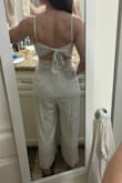 I'm a petite person and this fits me nicely. Helps that it has the tie back and adjustable straps. It's a bit hard to get over my hips to put on/take off but not awful. I am a little concerned that I'll eventually rip a seam though. Other than that, it seems well made and has a liner so it isn't see through! - Kasey C.