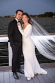 Buying things online, especially my wedding reception dress, is so scary! My husband and I eloped and then had a small family reception dinner a couple of months later. I wanted simple and classy, and this dress was everything I wanted. The back is beautiful; the sleeves were a little long but in a good/modest way, and the train was the perfect length (the tailor did not touch the train). I had the front hemmed bc I wore flats. So happy I committed to this beautiful and elegant dress. My chest is small, and there was definitely room for a bigger chest, too! I don't have my prof pics back yet, but hopefully, these pics prove something 10/10 (and I'm normally picky). - Wendy N.