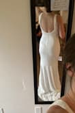 I bought this dress to try on for my elopement in August. It was shipped so quickly and exceeded my expectations! It fits almost perfectly. I am going to make the straps tighter; they are a bit too loose on my shoulders, and I need it hemmed as I'm on the shorter side and not wearing very tall heels. Other than that, it fits so well and the fabric is very nice, I also love that I won't have to worry about wrinkles. I love the vintage vibe of this dress; it is classy and timeless. The price is incredible for such a beautiful dress. - Megan H.