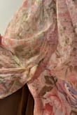Runs long. I'm 5'6" and wore 3-inch heels with it and still needed to hem it a couple of inches. There were lots of stitching errors, the sleeve got caught up in the seam, and at the bottom of the zipper it was bunching weirdly. I did not notice them until after the exchange policy period when I was getting it hemmed a week before the wedding. Over all the dress fits nicely everywhere but the length. It is a pretty print, just wish their quality assurance team was better and caught those flaws. I paid 100 dollars for it to wear to a wedding and now I'm stuck with it. - Anne A.