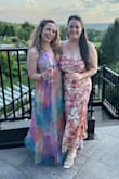 I got this dress for my oldest friend's wedding because the bright fun colors and beautiful cut reminded me of her. I am short, and I wore roughly 4" wedges. I had to trim the outer layer and hem the slip, but they were pretty easy fixes! The straps are very adjustable, and while it is low cut, I didn't have to worry about my dress falling down. One thing I will say (which was also an easy fix) is that the slits in the slip go up to like underwear level, so I stitched them up! - Maddie B.