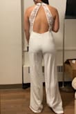 I liked the fit, but I wished the waistline was higher so that it would make my long torso appear shorter. Material is thicker and better quality than some other white Lulus jumpsuits/dresses - Dawn L.