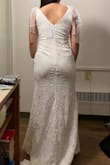 I wanted to get this dress for my wedding, but the material looked cheap in person and the ribbons made my neck appear shorter. Wasn't the most flattering on me sadly although it looked so elegant on the model :( - Dawn L.