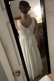 I tried on several dresses for a wedding where all the bridesmaids were asked to wear white. This was a very close contender! The fabric is heavy and felt very high quality. I'm normally a medium but sized down to a small. I liked how it looked from the back too. I felt like the thickness of the fabric smoothed everything out. Based on other reviews, I had intended to have the bust taken in if I chose the dress, but ultimately I chose another style. - Rachael B.