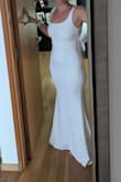 Bought this dress for a pre-wedding photoshoot. Firstly the material is really thick and stretchy and acts a little like shapewear (bonus! but prob not ideal for hot weather) and it was snug compared to other dresses I bought in the same size. As others have mentioned, the lining in the chest area meant there was a small extra fold of fabric just below the bust - it's manageable. The neckline, general cut and shape were super flattering, and love the bow detail. Length was just nice with heels at the front (I'm 5'6) with a nice small train at the back. I will try it for one of my photoshoot locations. 
side note, it had a couple snares in the fabric that started running when I received it, but Lulus was super quick to respond and resolve this for me :) - Elise R.