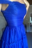I really liked this dress and felt like a princess but the arm straps were too small! I bought it for a wedding as the tulle overlay wouldn't show sweat and really liked the color and fit of it. The material was kind of sewn unevenly but not noticeable. However, the straps on the arms (one model is shown wearing them on her shoulders but the other has them off the shoulder - they won't stay up) were so tight I couldn't raise my arms up. So I wouldn't be able to dance or even put my hair up. For that reason, I returned it. - Julie T.