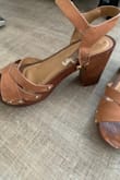 I absolutely love these. But unfortunately, I probably only wore them maybe 10 times and they fell apart. They are not wooden or leather. More like plastic. Such a shame. - Bree F.