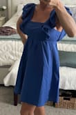 The blue color of this dress caught my attention as well as the ruffled sleeves, and I am not disappointed with my purchase! The material is a light cotton feel and you can see from the pictures it does need to be steamed or ironed, but nonetheless has a very feminine look to it. It's casual enough it can be worn as a nice summer dress or evening dinner out but also I think can be dressed up if you have a nice event. I did not get the dress on sale, and I share that to say that it was worth just getting it if you like it. It's a nice staple piece that will be in fashion for a while. I am petite framed and ordered the extra small and I have no complaints with the length or how it fits in the bust area, very flattering and classy. - Laura S.