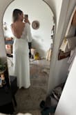 LOVE this dress! I usually am a s/m but sized down to an xs for a more snug and snatched look and it fits great - the back is slightly pulling in the picture (but also because I'm stretching to take the picture lol). The double lining helps keep things looking smooth, but you could still wear shapewear underneath. It hits just above the ground. I'm almost 5'9", but still wearing a 2.5" heel and it looks great. The slit is pretty high for me now as I have long legs / short torso, but just stitching it down a couple inches and it's great! No other alterations. I'm wearing this for my smaller, more conservative church ceremony <3 - Jenna L.