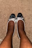 I bought this pair of flats as a cart filler (it was on sale for a good price) and wasn't displeased when I received it. It is a nice looking silver but I wouldn't consider it to be true to size as it fits loose. I would need to push my feet back otherwise my feet would be coming off as I walk. For reference I'm typically a 7.5 and a 7 would have been better. - Beverly B.