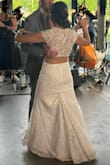 This dress was everything for my wedding! Lace fabric is light and airy to wear yet has a weight to it that is luxurious. I had the top fringe cut off during alterations to allow for some more neckline and had the dress taken in a bit at the hip since I tend to run in between S and M sizes. It was so comfortable to wear all day and hugged my body just right. Highly recommend! - Laura J.