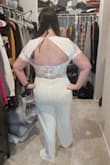 Purchased this for my upcoming bridal shower and LOVED it. It was one of the saddest moments having to send it back. When it zipped up it was beyond gorgeous on and with the right shapewear would have been phenomenal. I'm a curvier girl so jumpsuits in white are scary to try on and this one made me feel like a goddess.
However, due to the lace on the sleeves, they have no stretch or give where they connect on the underside so I was unable to lift my arms. AT ALL. Was I considering keeping it and just not lifting my arms the whole day? Yes. Was I considering spending money to see if a seamstress could fix it so I could keep it? Yes. Ultimately I decided it would cost too much and cried as I put it back in the bag. Hopefully, it will work for you, because it's beautiful. - Carly W.