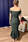 This dress was beautiful and very flattering from the back. However, on my body it caused me to look like a had a "mom pouch". I just didn't think it was flattering from the front. This very well could be just from my body type. The material is also pretty thick and not super stretchy. - Megan S.