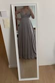 The dress looks very good, especially for its price. The material feels nice. The upper part is a bit tight and it is a struggle to zip it up, but that's better than it being loose. The only issue I have with the dress is that it's a bit too long, and it feels like I am probably going to trip on it at some point in the night :D. Obviously, it needs some straightening, but that is to be expected. - Maria T.