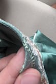 The embroidery on the dress I received was more sparse than that on the model. Plus, threads on both the design and the satin were out of place and coming undone. Very disappointed. - Emma L.