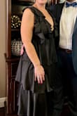 This gown was gorgeous! I knew it, and everyone else said so! It was very flattering and mega comfy for a very formal environment. The ruffled tiers start high instead of at the hip, which was lovely. I needed NO BRA and felt totally supported 100% of the time- no adjustments needed! I ordered the Large and XL but immediately returned the XL after only trying on the Large, as it was a perfect fit. The tie-back acted as an adjustment for sizing & support, as well as pretty detailing for the backside of the gown. - Ginger G.